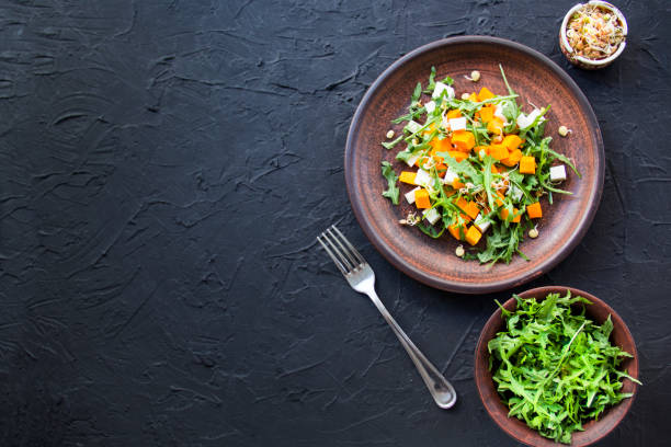 Delicious healthy pumpkin salad with arugula and cheese