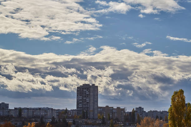 Cloud masses with strong vertical development over the city, cumulus clouds above the buildings of a modern city, representing the arrival of autumn.