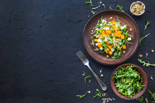 Delicious healthy pumpkin salad with arugula and cheese