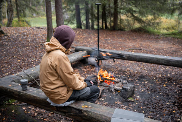 istock man cooking on a campfire in the forest 2183566560
