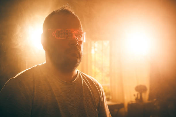 Man in glasses lit by bright lights in New York, New York, United States