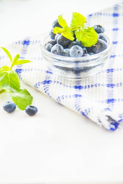 Juicy and fresh blueberries with green leaves. Creative atmospheric decoration
