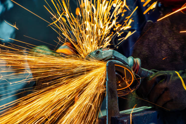 istock angle grinder, handyman worker using power tools grinding metal in a factory 2183577300