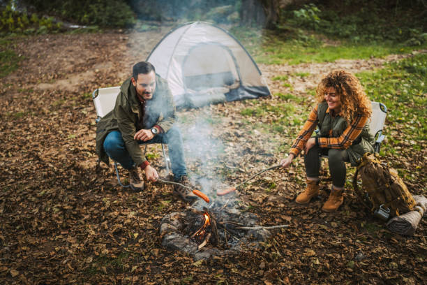 istock hiker couple enjoy on the camp while grill sausage in front tent 2183580389