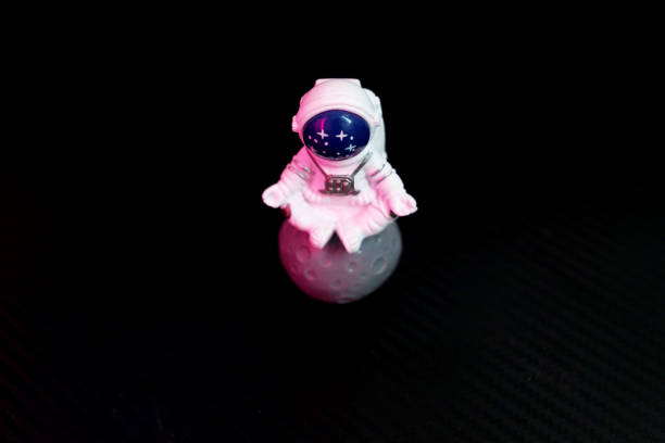 Astronaut toy on black background