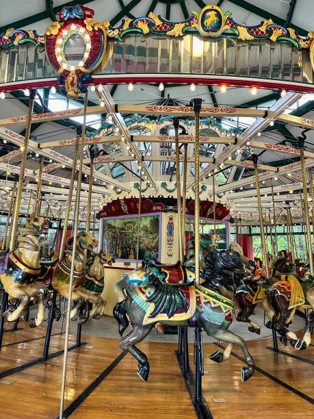 istock Beautiful carousel amusement ride with shiny colorful horses 2183587325