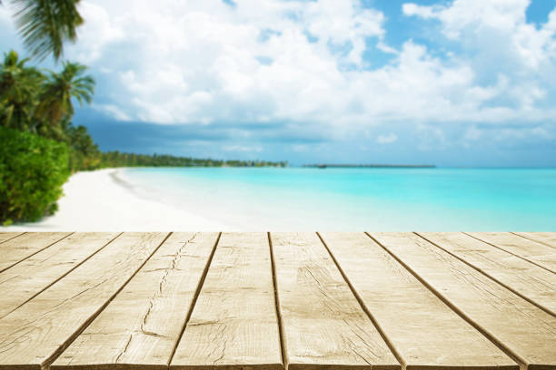 istock Empty wooden table top with beautiful tropical paradise beach background 2183600122