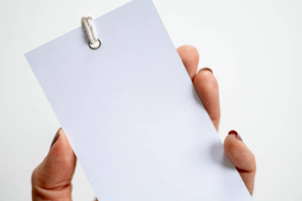 istock Hand holding blank white label on clean white background. 2183605613