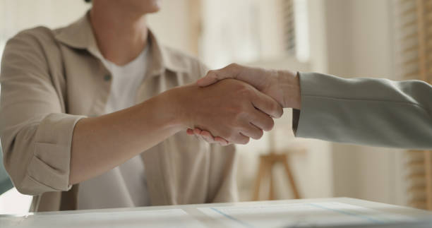 istock Two Business Professionals Shaking Hands in Office. 2183606131