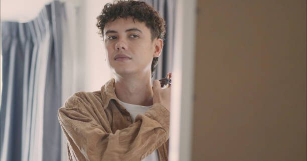 istock Young Man Applying Perfume at Home. 2183606466