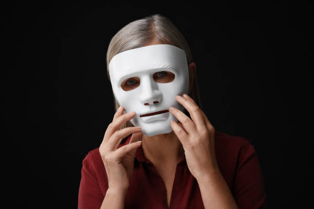 istock Multiple personality concept. Woman in mask on black background 2183608246