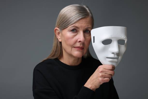istock Multiple personality concept. Woman with mask on gray background 2183608283