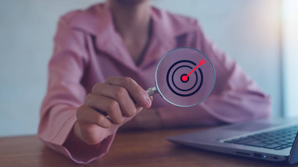 istock Target board inside magnifying glass for focus business objective on gray background and copy space. Search, goal, strategy, success. 2183608419