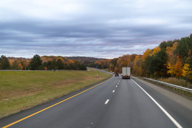 A car and a truck are effectively making their way down a winding and curvy road while navigating through the twists and turns ahead