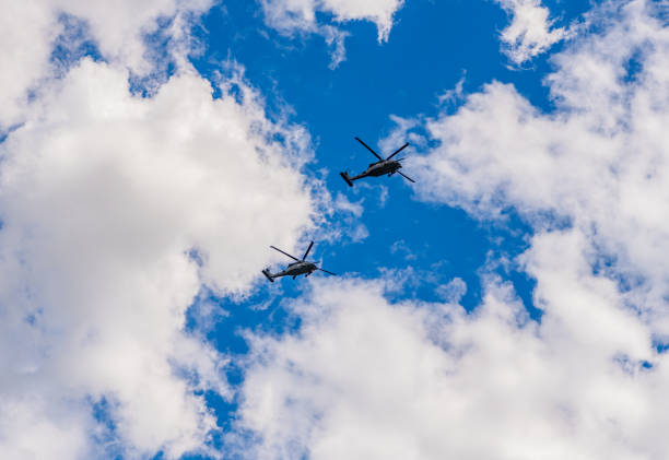 istock heli copter flight. helicopter transport. helicopter flying in the sky. two helicopter rotorcraft. police helicopter. Flying heli copter 2183610331