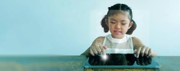 istock Checklist concept. Little girl tapping with a tablet checking digital checklist form. Online homework, assignment, study,  survey, assessment, evaluation, questionnaire, research, feedback, and test. 2183613694