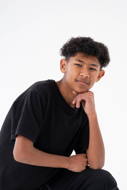 istock Studio shot of a young boy with curly black looking at the camera 2183618140