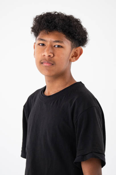 istock Studio shot of a young boy with curly black looking at the camera 2183618225