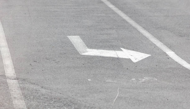 istock A white arrow is drawn on a grey road 2183618226