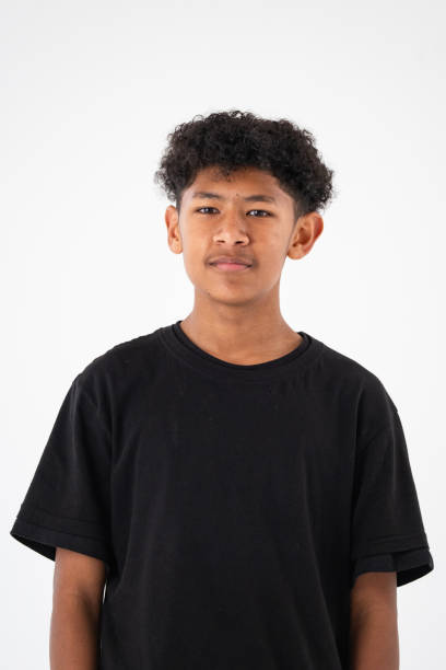 istock Studio shot of a young boy with curly black looking at the camera 2183618248
