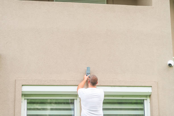 istock Electrician installing outdoor wall light fixture on building facade 2183621086