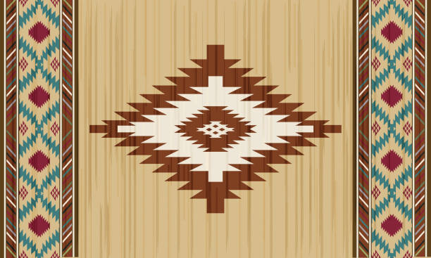 A close-up view of a colorful geometric patterned fabric. The design features zigzag lines in orange, green, and brown hues, creating a vibrant and textured appearance.