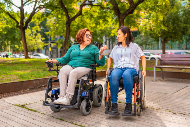 istock Cheerful friends with disability talking in a park 2183622165