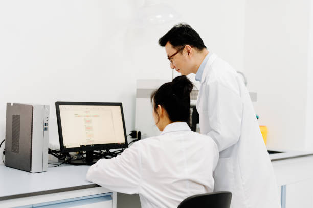 istock Two Asian scientists working on the computer and  digital tablet in laboratory. 2183623284