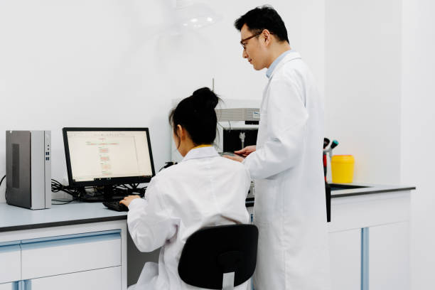 istock Two Asian scientists working on the computer and  digital tablet in laboratory. 2183623291