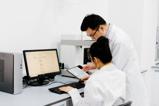 istock Two Asian scientists working on the computer and  digital tablet in laboratory. 2183623294