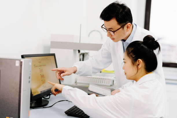 istock Two Asian scientists working on the computer and  digital tablet in laboratory. 2183623310