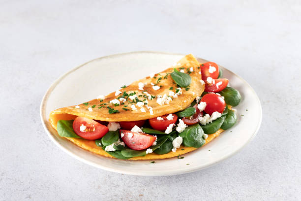 istock Stuffed omelette with tomatoes, cheese and spinach on a white background. 2183625369