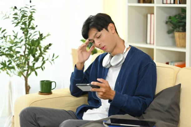 istock Young asian man playing a video game on smartphone feeling upset after loosing 2183625680