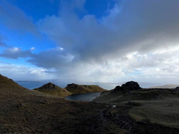 istock Scenic landscape with hills and lake under cloudy sky. 2183628072