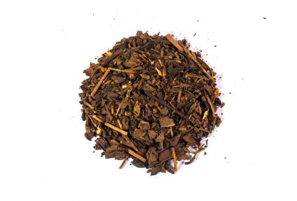 istock Dried tea leaves isolated on white background. Tea is a caffeinated beverage, an infusion made by steeping the dried leaves, leaf buds, or leaf stalks of the Camellia sinensis plant in hot water. 2183630494