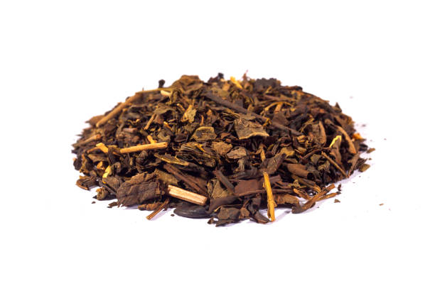 istock Dried tea leaves isolated on white background. Tea is a caffeinated beverage, an infusion made by steeping the dried leaves, leaf buds, or leaf stalks of the Camellia sinensis plant in hot water. 2183630496