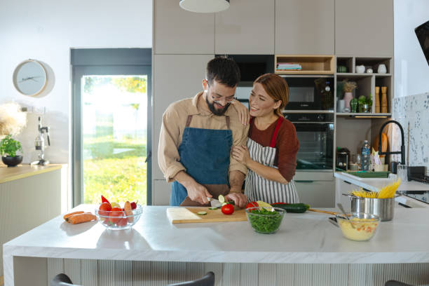 istock Couple enjoying cooking together in a modern bright kitchen 2183632181