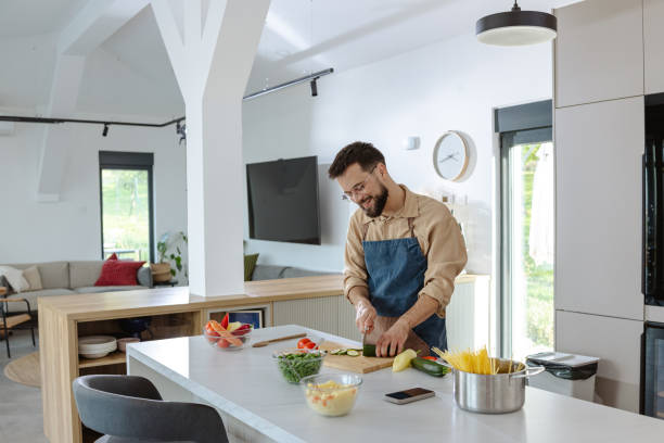 istock Man preparing a healthy meal in modern kitchen with fresh ingredients 2183632191