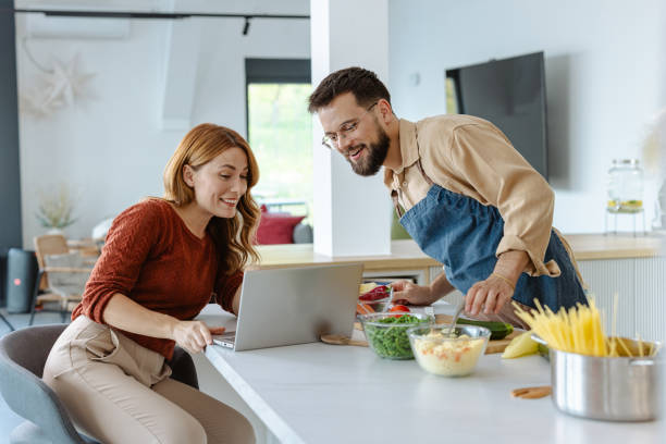 istock Couple cooking together and enjoying time in modern kitchen 2183633220