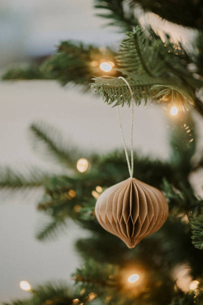 Christmas ornament bauble close up hanging in tree low key