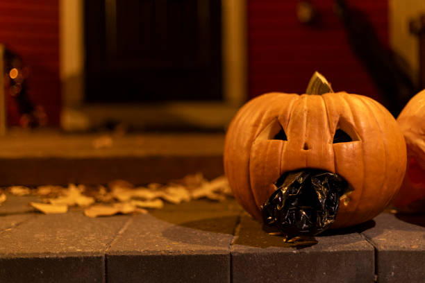 istock A carved-face pumpkin is placed by the house 2183638391