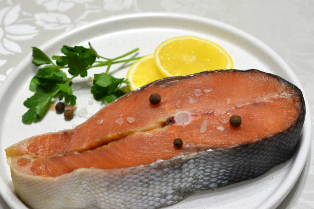 istock a plate with trout steak and a yellow lemon close up 2183638407