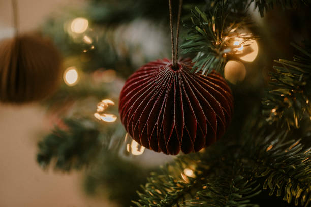 Christmas ornament bauble close up hanging in tree low key