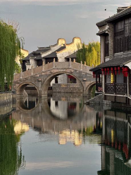 istock Traditional Chinese architecture with a bridge reflecting on a calm canal in a serene water town 2183638659