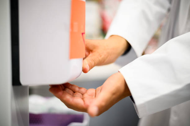 istock Doctor is using automatic hydroalcoholic gel dispenser for hand disinfection 2183638792