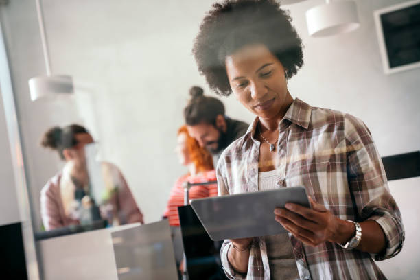 istock Success black happy business woman using tablet computer and working. Designer manager in her office 2183639931