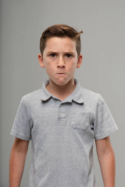 Portrait of angry tween boy, John M Lund