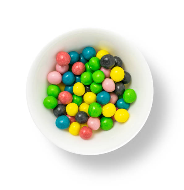 istock Colorful sweet chocolate candy in a bowl isolated on white background 2183640646