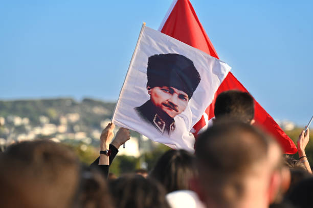 Istanbul - Maltepe, Turkey - October 29, 2024: During the Republic Day celebrations, enthusiastic people hold the Turkish flag and the flag of Atatürk, the founder of the republic, together.