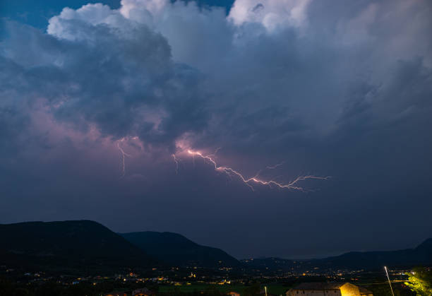 istock Lightning discharge with side branches high in the sky above the mountains 2183644529